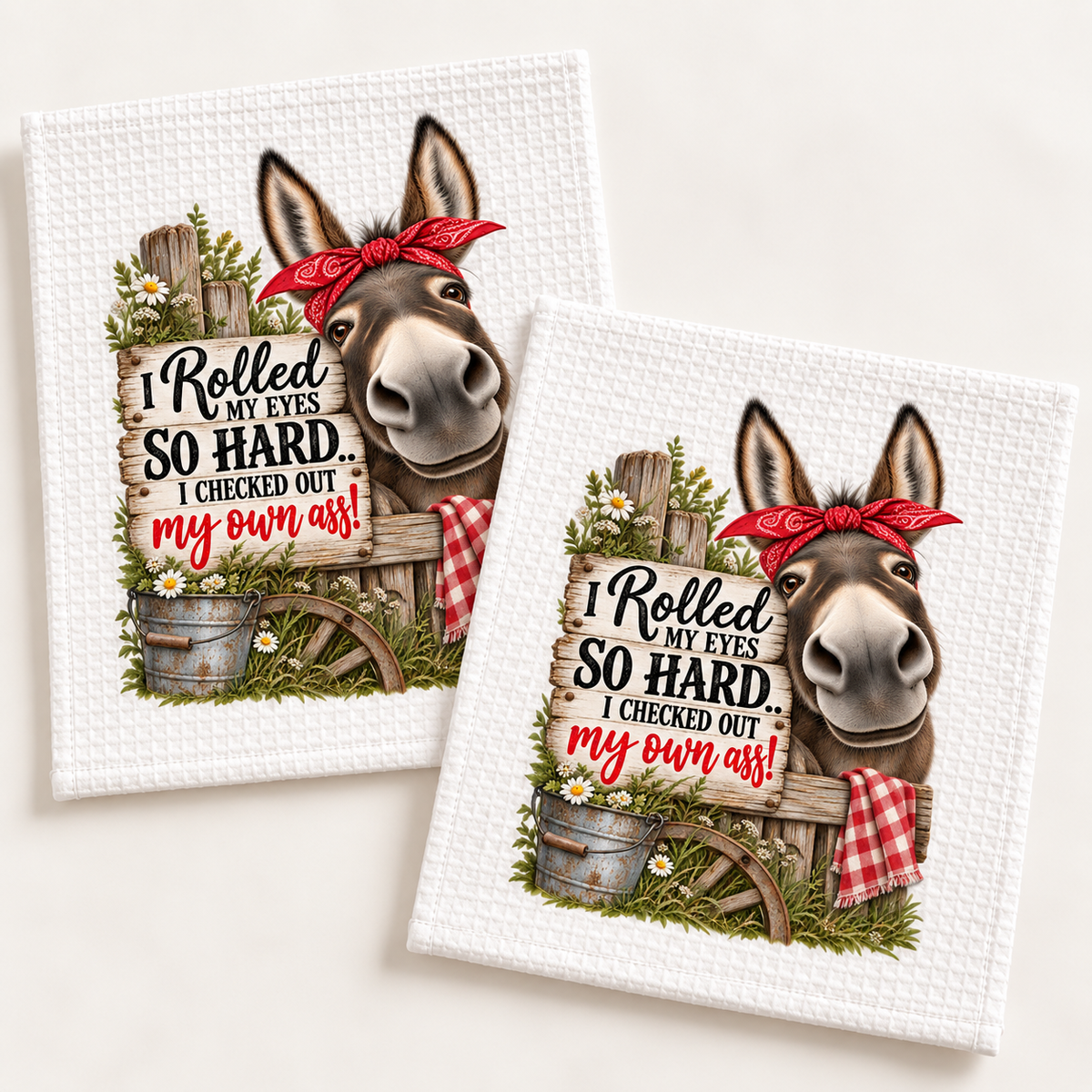 Two white waffle dishcloths with funny donkey artwork and red bandana