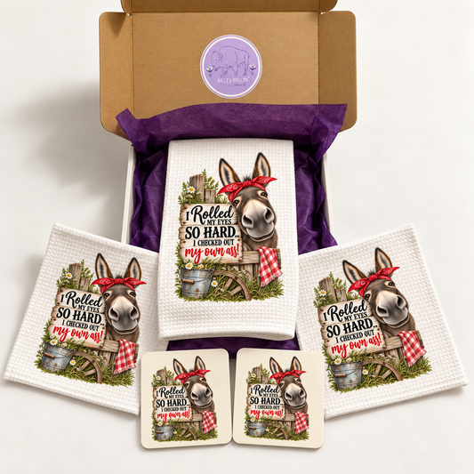 Funny donkey kitchen gift set with towel, two dishcloths and two coasters displayed with Salty Bison gift box